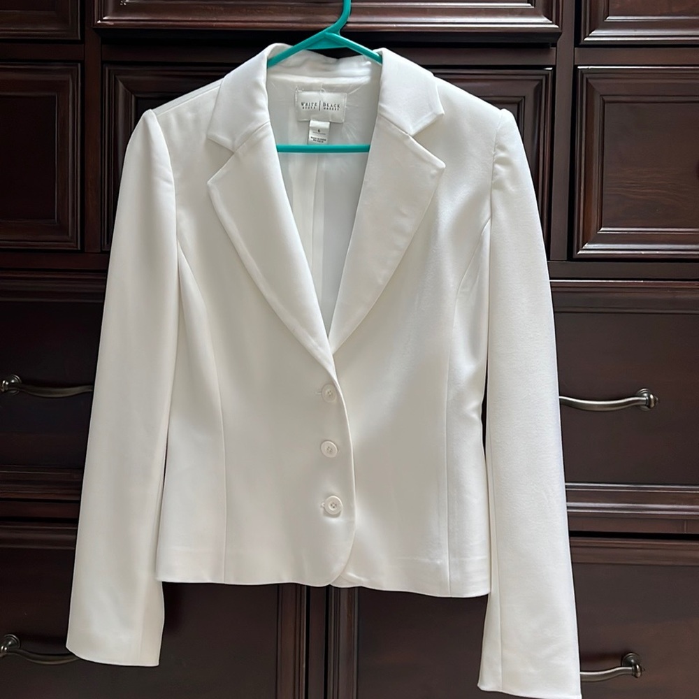 White House Black Market white women’s blazer with tie belt.